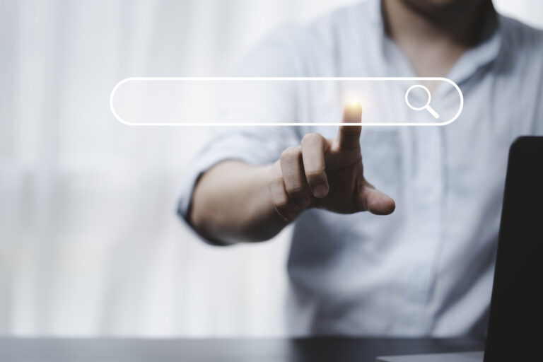 Hand touching with search icon for Search Engine Optimisation or